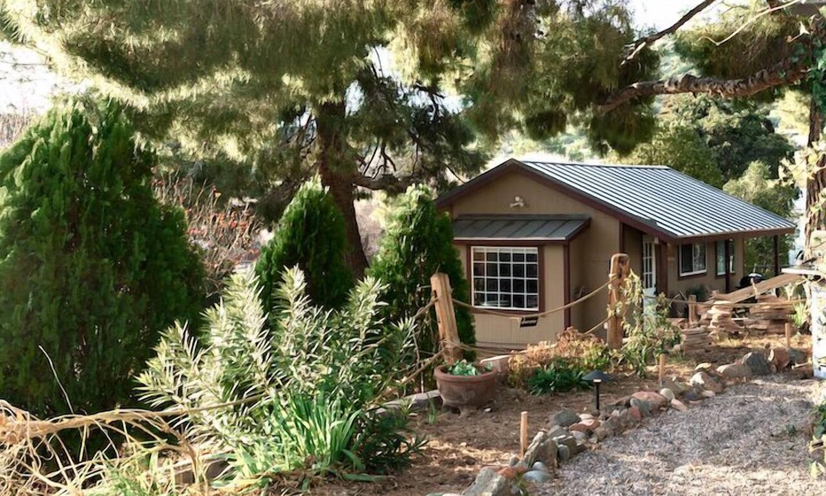 Cornville House | Tucked among pines on 1.3 dark-sky acres, this secluded king suite features a kitchenette, deep soaking tub, and patio with rocking chairs & grill. Stargaze beneath towering trees, explore lush gardens, and savor proximity to Page Springs vineyards.