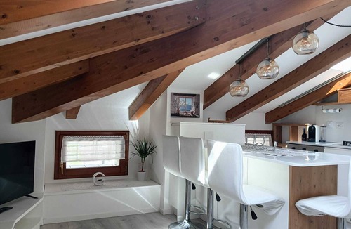 Levico Terme Apartment | Elegant attic with Dolomites view, relaxation and nature in Levico Terme.