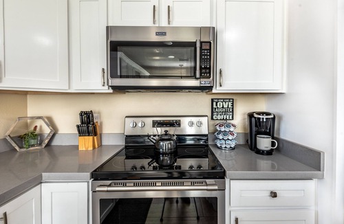 Phoenix House | Resort Style Backyard- Heated Pool, Putting Green, Outdoor TV and Pool Table.