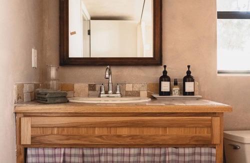 Cornville House | Tucked among pines on 1.3 dark-sky acres, this secluded king suite features a kitchenette, deep soaking tub, and patio with rocking chairs & grill. Stargaze beneath towering trees, explore lush gardens, and savor proximity to Page Springs vineyards.